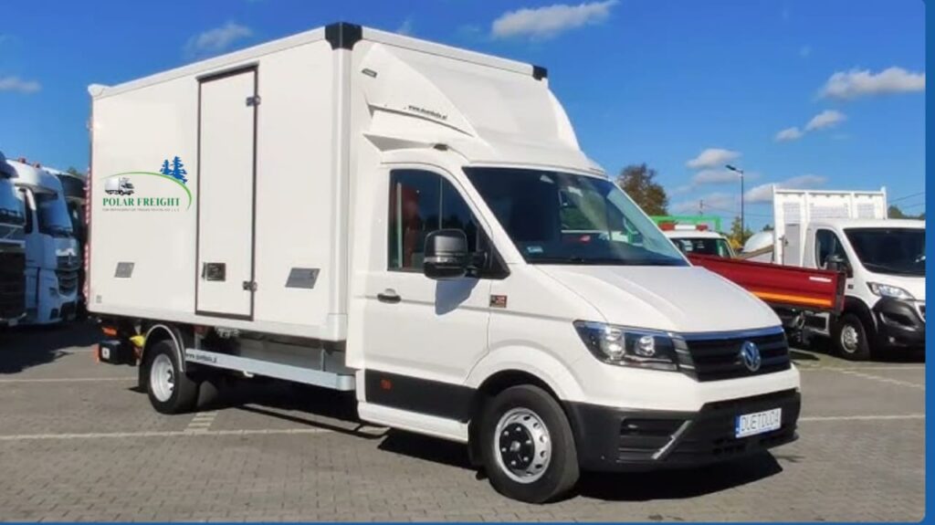 Refrigerated chiller van parked for rental with open rear doors showing cold storage interior